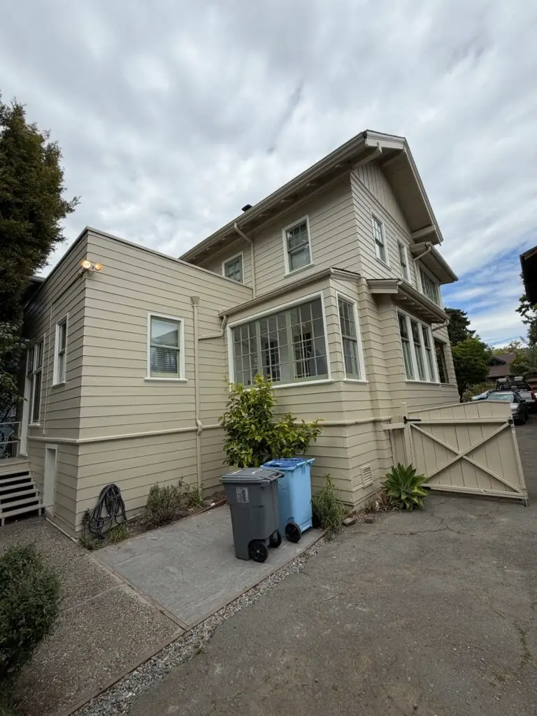 Freshly painted cream-colored two-story house exterior by Wilmar's Painting