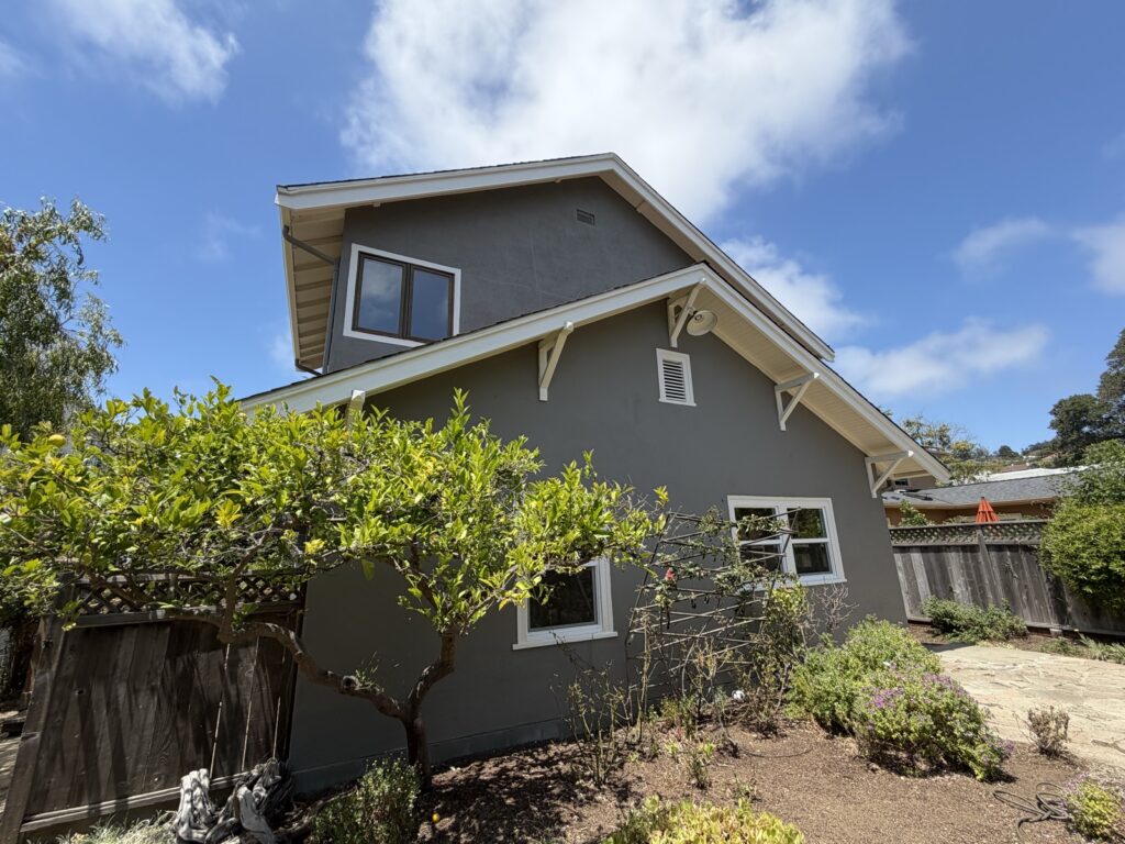 Dark gray Craftsman-style home exterior with crisp white trim, painted by Wilmar's Painting
