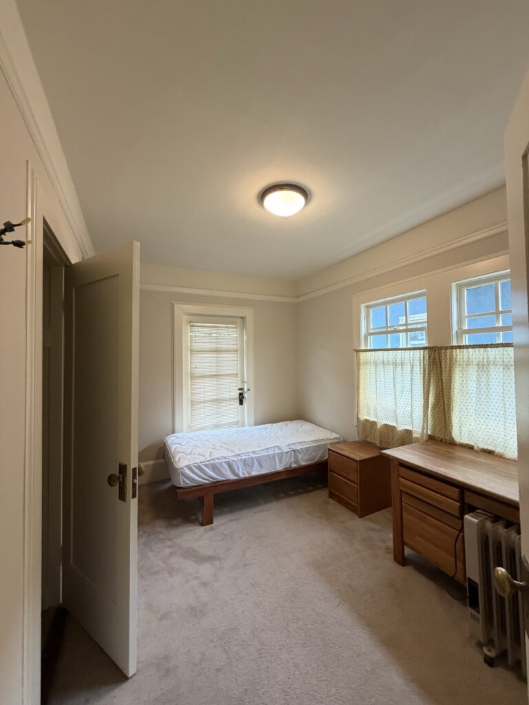 Freshly painted bedroom with white walls and crown molding by Wilmar's Painting