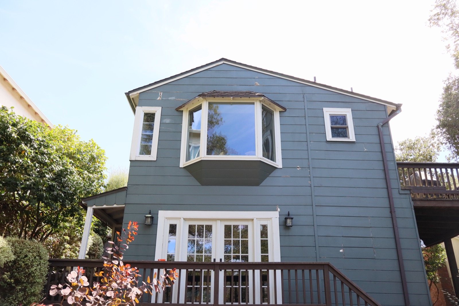 Blue-grey home with bay window repainted