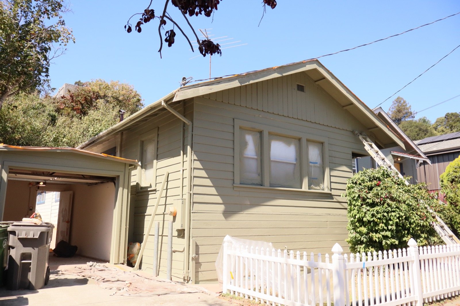 Sage green bungalow with white picket fence