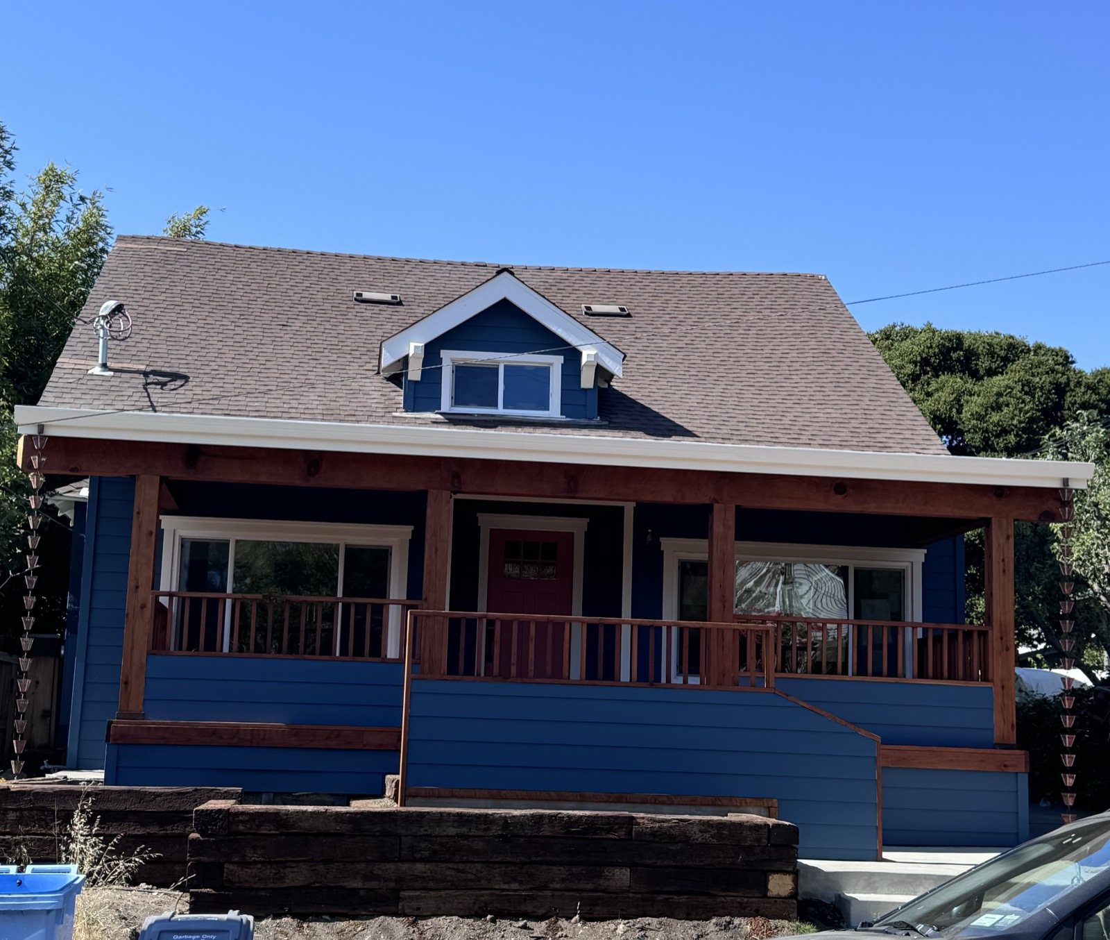 Blue craftsman home with front porch repainted