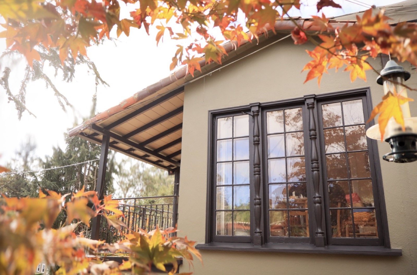 Tan home with bay window, exterior repaint