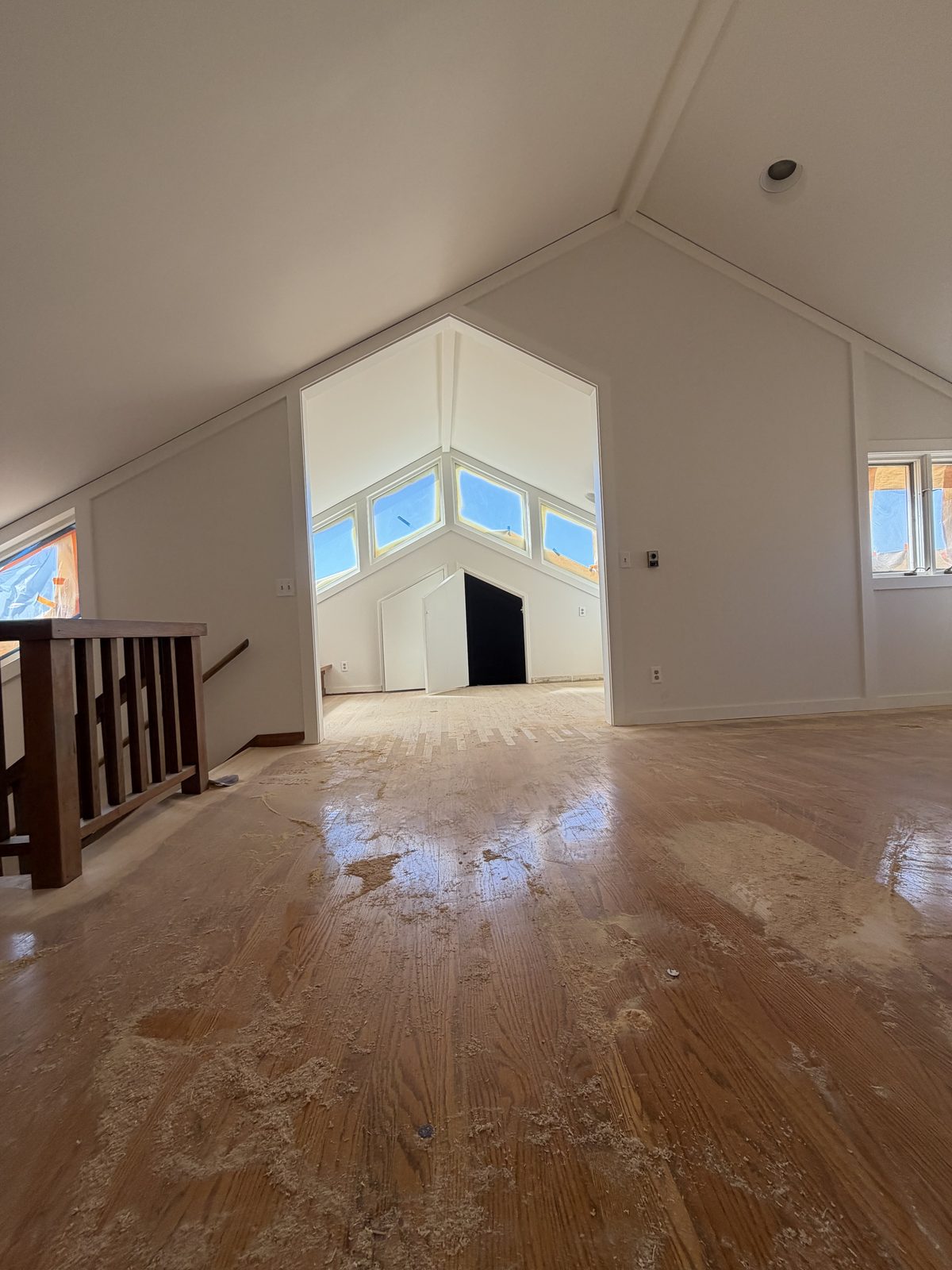 Vaulted-ceiling room with freshly painted white walls by Wilmar's Painting