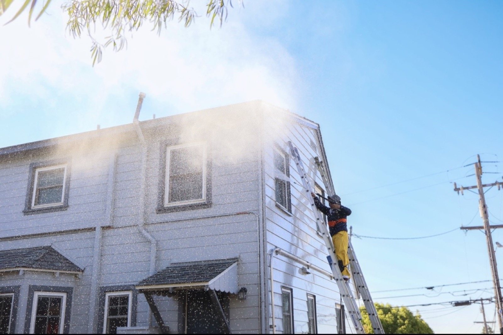 Power washing a home exterior before painting